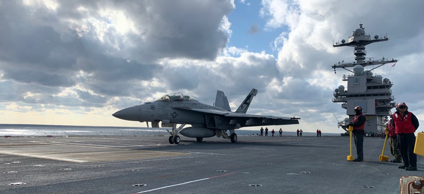 Crews ready an F/A-18 Super Hornet for take off on the deck of USS Gerald R. Ford on Monday Jan. 27.