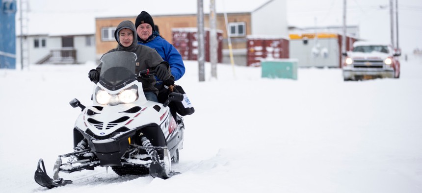 Census Bureau Director Steven Dillingham, center in blue jacket, rides behind Dennis Kashatok as they arrive to conduct the first enumeration of the 2020 Census on Jan. 21 in Toksook Bay, Alaska. 
