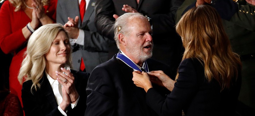 First Lady Melania Trump presents the Presidential Medal of Freedom to Rush Limbaugh as his wife Kathryn watches during the State of the Union address on Tuesday.