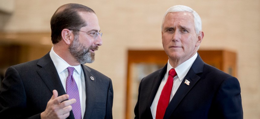 Vice President Mike Pence (right) and Health and Human Services Secretary Alex Azar speak as Pence arrives for a coronavirus task force meeting at HHS on Thursday.
