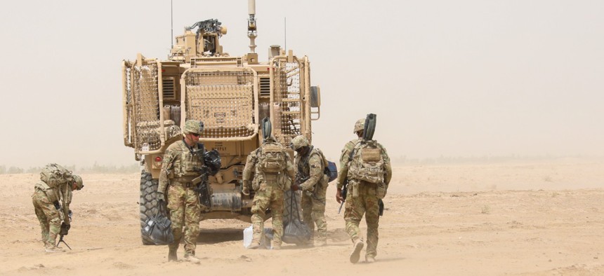 U.S. Army Soldiers from 2nd Infantry Brigade Combat Team, 4th Infantry Division, unload humanitarian aid supplies from a tactical military vehicle in 2018.