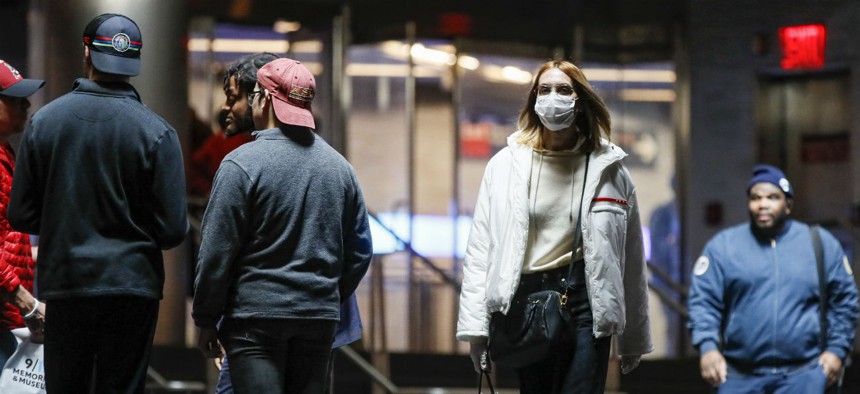 A commuter wears a face mask in the New York City transit system, Monday, March 9, 2020, in New York.