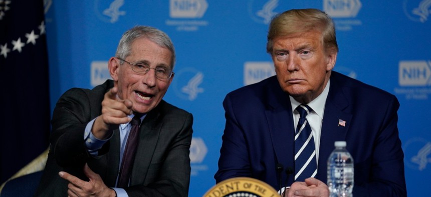 National Institute for Allergy and Infectious Diseases director Dr. Anthony Fauci, left, speaks with President Donald Trump at the National Institutes of Health, Tuesday, March 3.
