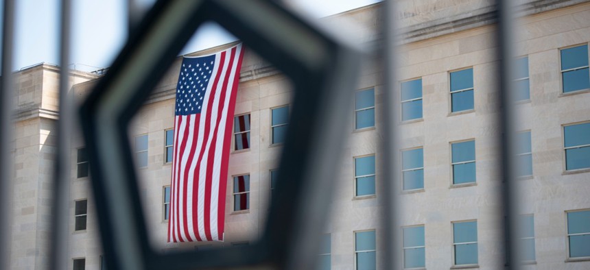 An American flag, unfurled at dawn, hangs over the Pentagon on the anniversary of the 9/11 attacks on Sept. 11, 2019.