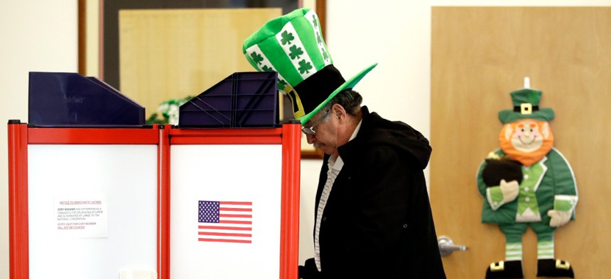A voter fills out his ballot, taking advantage of early voting on Sunday in Steubenville, Ohio. 