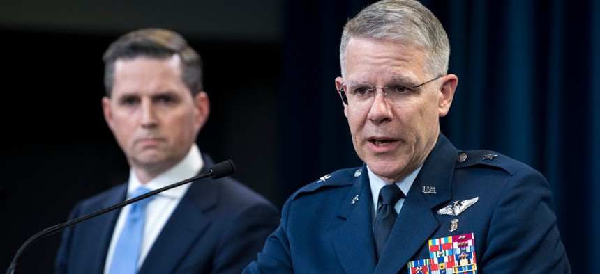 Assistant to the Secretary of Defense for Public Affairs Jonathan Rath Hoffman listens as  Joint Staff Surgeon Air Force Brig. Gen. (Dr.) Paul Friedrichs briefs the media about the Defense Department’s response to COVID-19 on Monday.