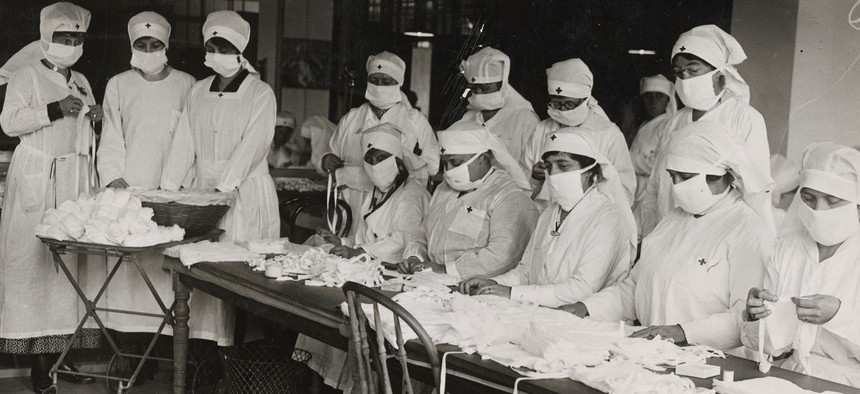 Red Cross workers making anti-influenza masks for soldiers in camp in Boston in 1918.