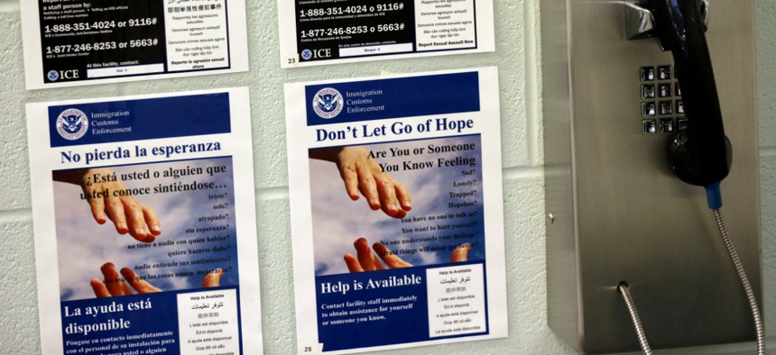 Information signs are seen next to a phone at the Karnes County Residential Center in 2014.