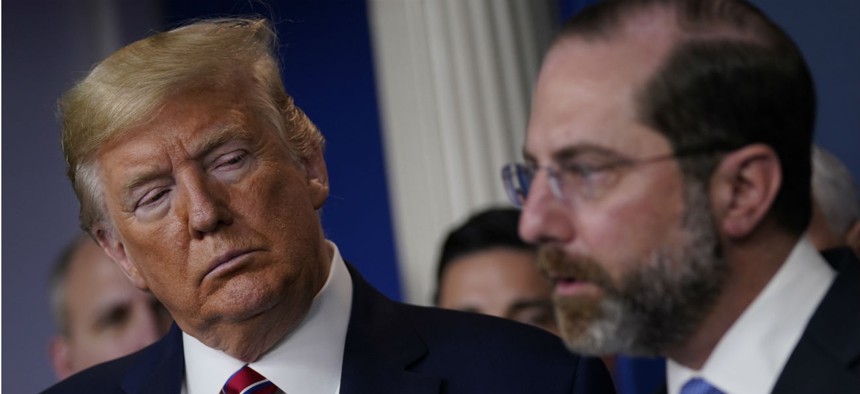 President Trump listens as Department of Health and Human Services Secretary Alex Azar speaks during a coronavirus task force briefing at the White House on March 20.