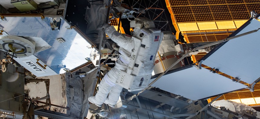 Spacewalker and NASA astronaut Christina Koch retrieves hardware from a pallet delivered on the Japan Aerospace Exploration Agency's HTV-7 to continue upgrading the International Space Station's power storage capacity in 2019.