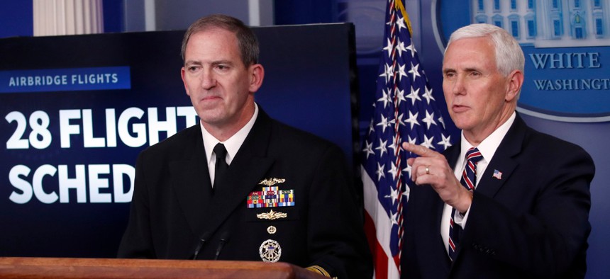 Navy Rear Adm. John Polowczyk, supply chain task force lead at FEMA, and Vice President Mike Pence speak about the coronavirus in the James Brady Press Briefing Room of the White House on Thursday. 