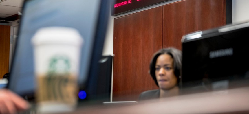 Digital clocks from different time zones around the world are displayed above Drug Enforcement Administration agents and intelligence analysts gathering information from field operations nationwide at their command center on March 11. 
