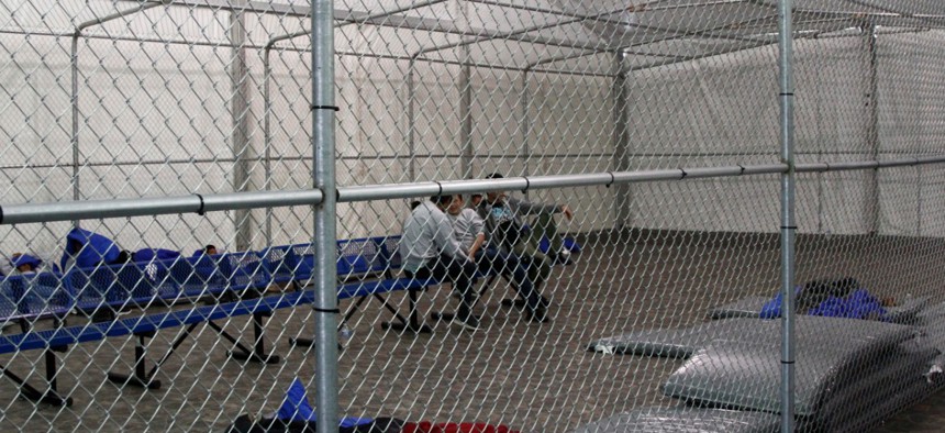 Migrants are detained in a tented, air-conditioned cage at a Border Patrol detention facility in Tornillo, Texas in 2019.