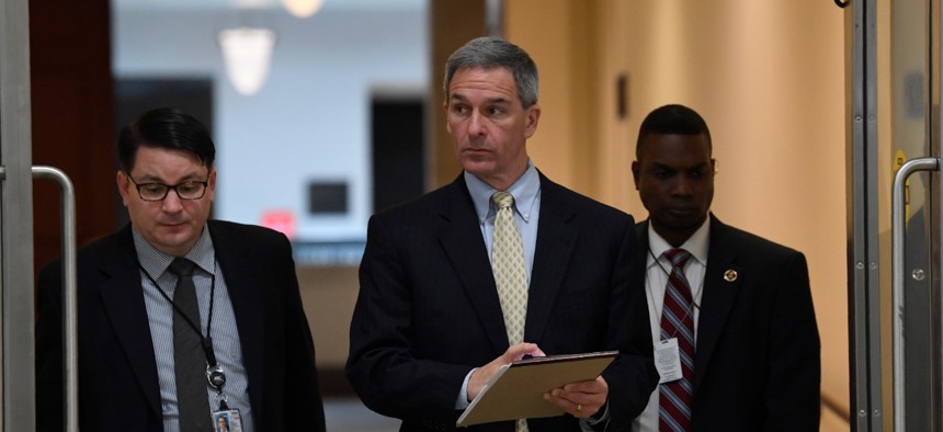 Ken Cuccinelli, center, acting director for the U.S. Citizenship and Immigration Services at the Homeland Security Department, briefs lawmakers on coronavirus on March 12. A federal court has ruled that he occupies the position illegally. 