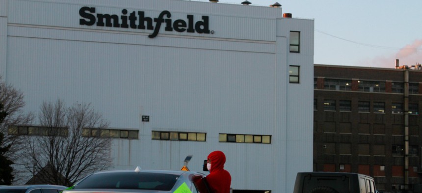 Employees and family members protest outside a Smithfield Foods processing plant in Sioux Falls, S.D. 
