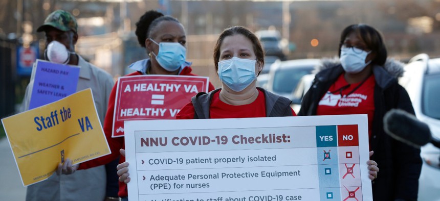 Nurses and other staff outside the Brooklyn Veterans Administration Medical Center on April 6 in New York to call for more personal protective equipment and staffing assistance to care for COVID-19 patients.
