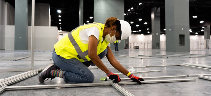 The Miami Beach Convention Center is now a 24-hour construction site, with crews working at a steady pace to install ICU and acute care pods.