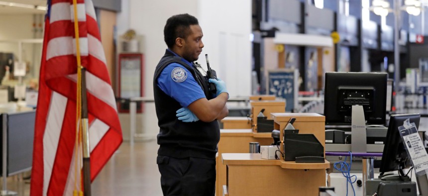 TSA officer C.J. Brooks stands waiting for a passenger to screen in a nearly empty Seattle-Tacoma International Airport on April 15. 