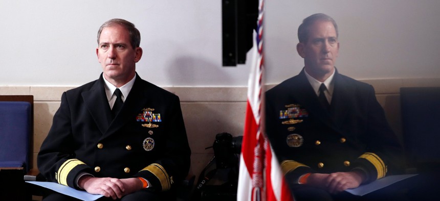 Navy Rear Adm. John Polowczyk, supply chain task force lead at FEMA, listens as President Trump speaks at the White House on April 13 about the government's response to the COVID-19 pandemic.  