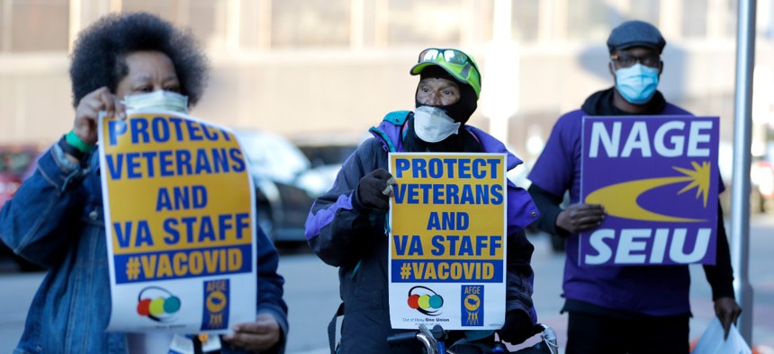 Activists from the American Federation of Government Employees local 424 and the National Association of Government Employees local R3-19 picket during the coronavirus pandemic, outside the Baltimore VA Medical Center, Wednesday, April 22