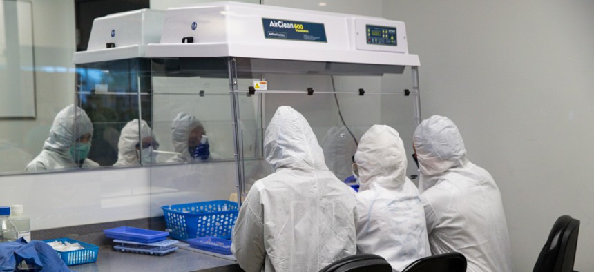 Workers at Aria Diagnostics assemble COVID-19 tests in Indianapolis on Thursday. 