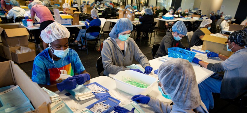 Workers at Aria Diagnostics assemble COVID-19 tests in Indianapolis, Thursday, April 23, 2020. The company donated 50,000 kits to New York City and is selling the city 50,000 per week for the next two months.