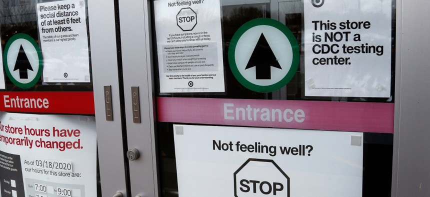 Shoppers to a Super Target store Thursday, April 23, 2020, in Minnetonka, Minn. are greeted with numerous signs related to the coronavirus issues. 