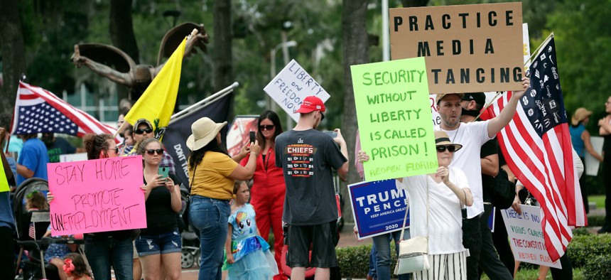 Protesters demanding Florida businesses and government reopen, march in downtown Orlando on April 17.