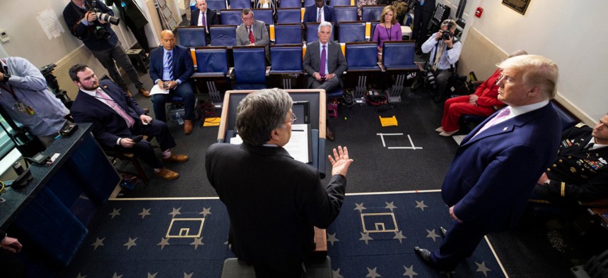Attorney General William Barr, left, speaks as President Donald Trump listens, during the White House coronavirus briefing on April 1.