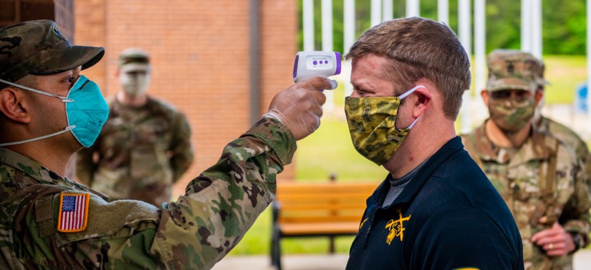 Secretary of the Army Ryan McCarthy has his temperature taken at 30th Adjutant Battalion (Reception) during his visit to the Maneuver Center of Excellence April 29. 