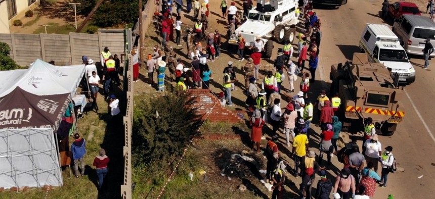 Thousands line up to receive food handouts in the Olievenhoutbos township of Midrand, South Africa, on May 2. 