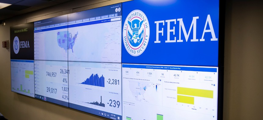 A screen shows information about the novel coronavirus at the Federal Emergency Management Agency headquarters on April 20. 