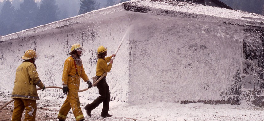 A firefighting crew foaming a dormitory at Mammoth Hot Springs during the 1988 Yellowstone fire. Firefighting foams are among the many substances that contain PFAS.