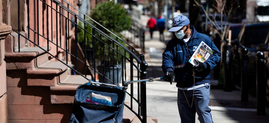A postal worker delivers mail in Philadelphia on April 2. 