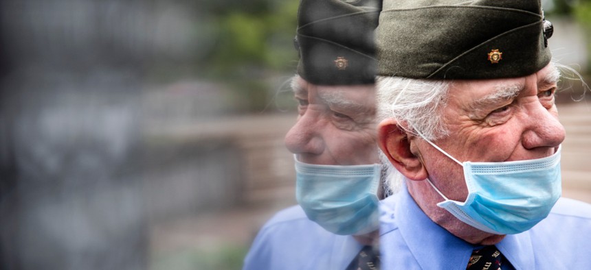 Americans are slowly returning to work and public places, despite the ongoing pandemic. Above, Marine Corps veteran John Kline pays his respects at the Korean War Memorial in Philadelphia on Memorial Day.