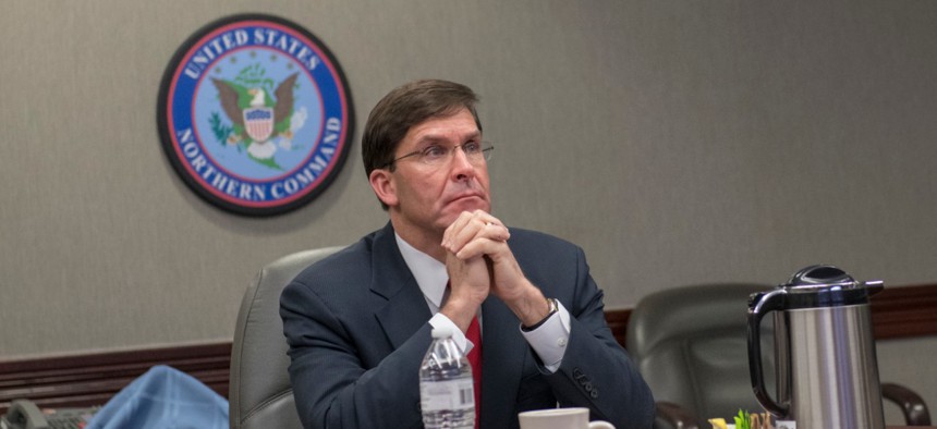 Defense Secretary Mark Esper receives a COVID-19 briefing from Gen. Terrence J. O'Shaughnessy, commander of North American Aerospace Defense Command and U.S. Northern Command, on May 7. 