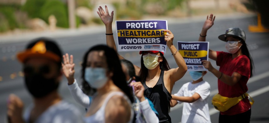 Health care workers protest what they say are unsafe working conditions outside of MountainView hospital in Las Vegas on April 30, and demand that OSHA intervene. 