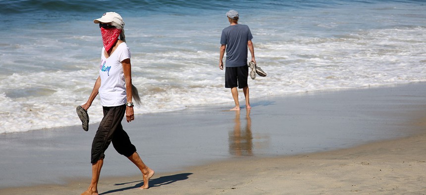 People walk at Laguna Beach, California on May 20.