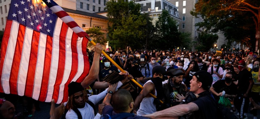 Demonstrators clash as people gather to protest the death of George Floyd, Saturday, May 30, 2020, near the White House.