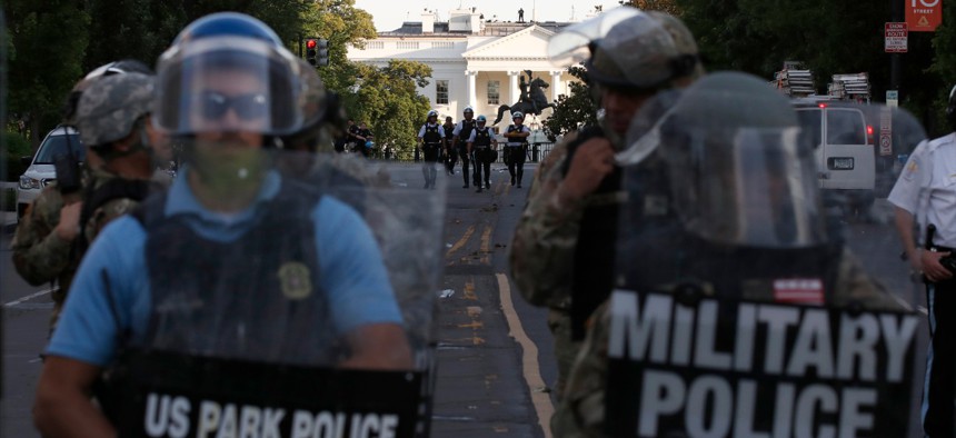 Police clear the area around Lafayette Park and the White House as demonstrators gather to protest the death of George Floyd on Monday, June 1.