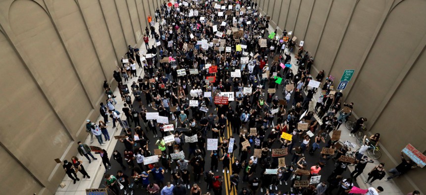 Protesters march Thursday, June 4, 2020, in San Diego. Protests continue in U.S. cities, sparked by the death of George Floyd, a black man who died after being restrained by Minneapolis police officers on May 25.