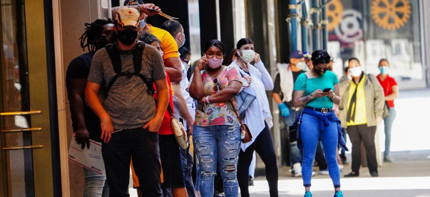 People line up at Paramount Theater Times Square during the coronavirus pandemic on May 27, 2020 in New York City.