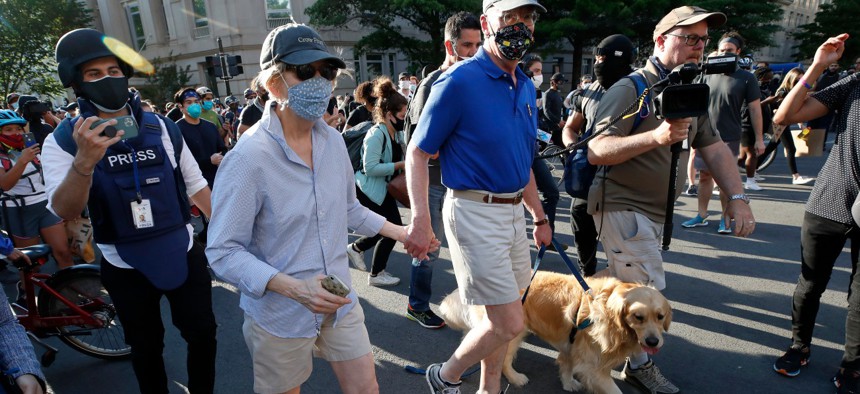 Sen. Elizabeth Warren, D-Mass., walks with her husband and dog on June 2 near the White House as demonstrators gather to protest the death of George Floyd. Warren is one of the senators seeking a probe of 'Project Airbridge.' to obtain medical supplies. 