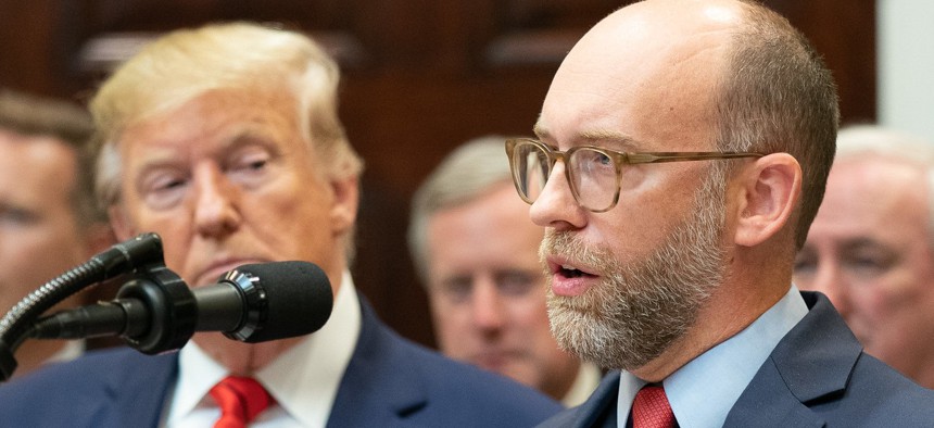 Acting White House Budget Director Russell Vought speaks at a news conference last fall as President Trump looks on.