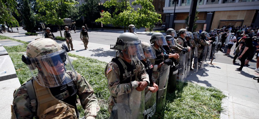 U.S. Army members form a police line on 16th Street as demonstrators gather in Washington, D.C. on June