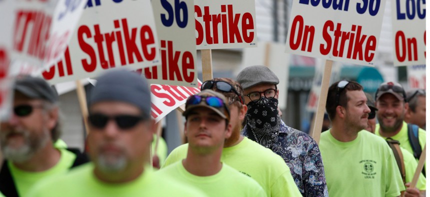Striking shipbuilders picket outside an entrance to Bath Iron Works in Maine on Monday. 