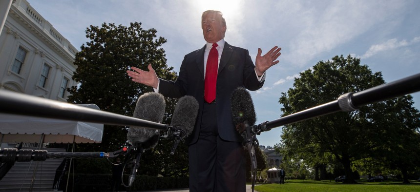 President Trump speaks with reporters before departing on Marine One on the South Lawn of the White House on Tuesday.