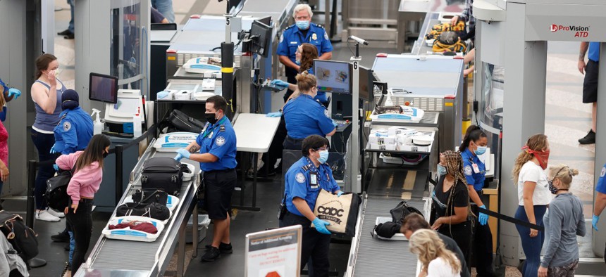 Transportation Security Administration agents process passengers at the south security checkpoint in Denver International Airport on June 10. 