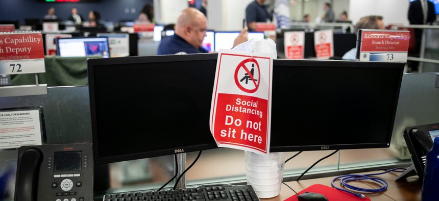 An empty desk shows a sign enforcing social distancing at the Federal Emergency Management Agency headquarters in April. 