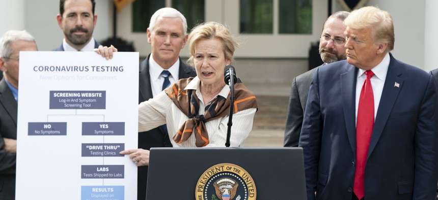 President Donald Trump listens as Ambassador Debbie Birx, White House Coronavirus Response Coordinator, addresses her remarks at a news conference where President Trump announced a national emergency to further combat the coronavirus on March 13.